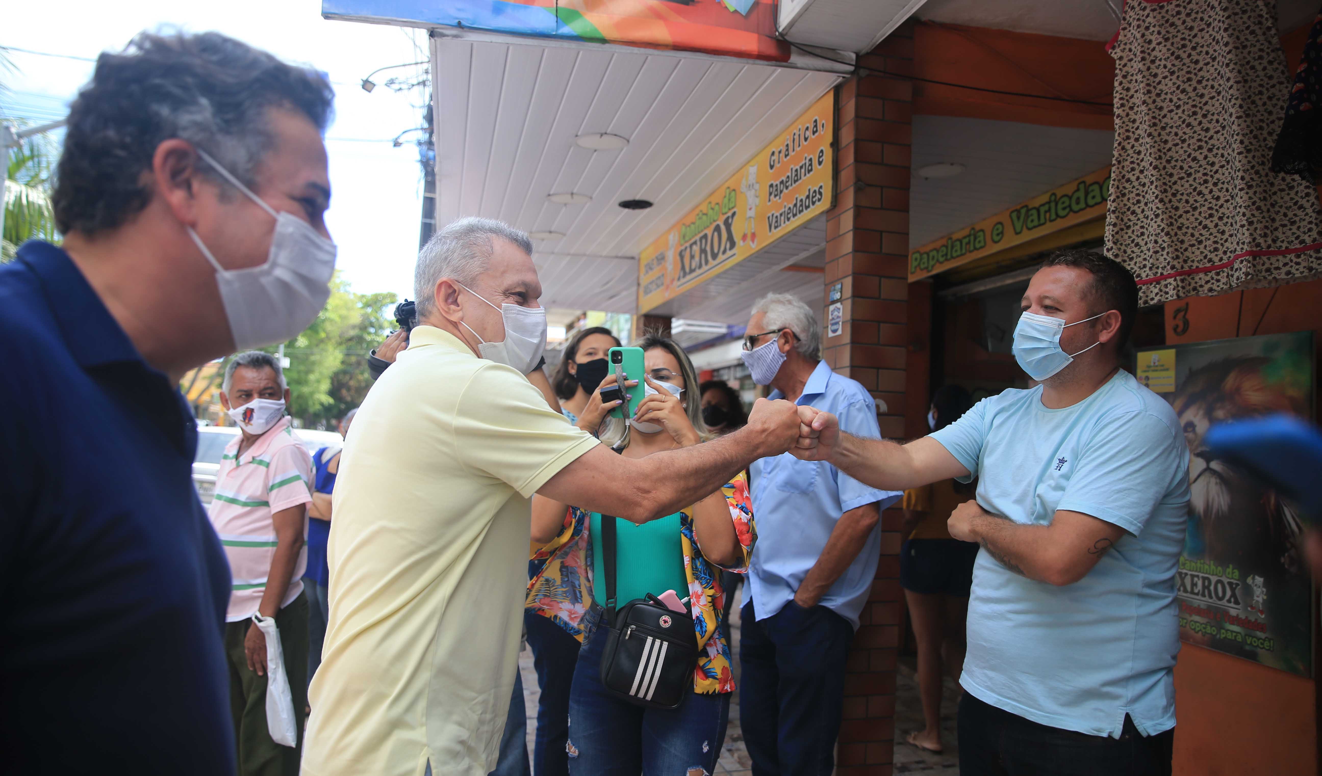 sarto cumprimenta um comerciante na entrada de sua loja